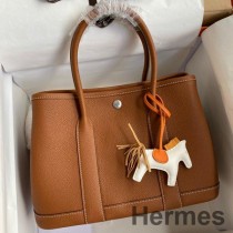 Bolsa Hermes Garden Party 30 feita à mão em couro Clemence dourado
